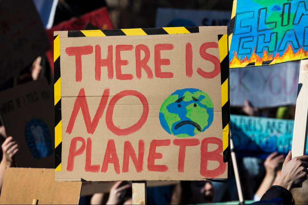 Protestors holding climate change banners at a protest